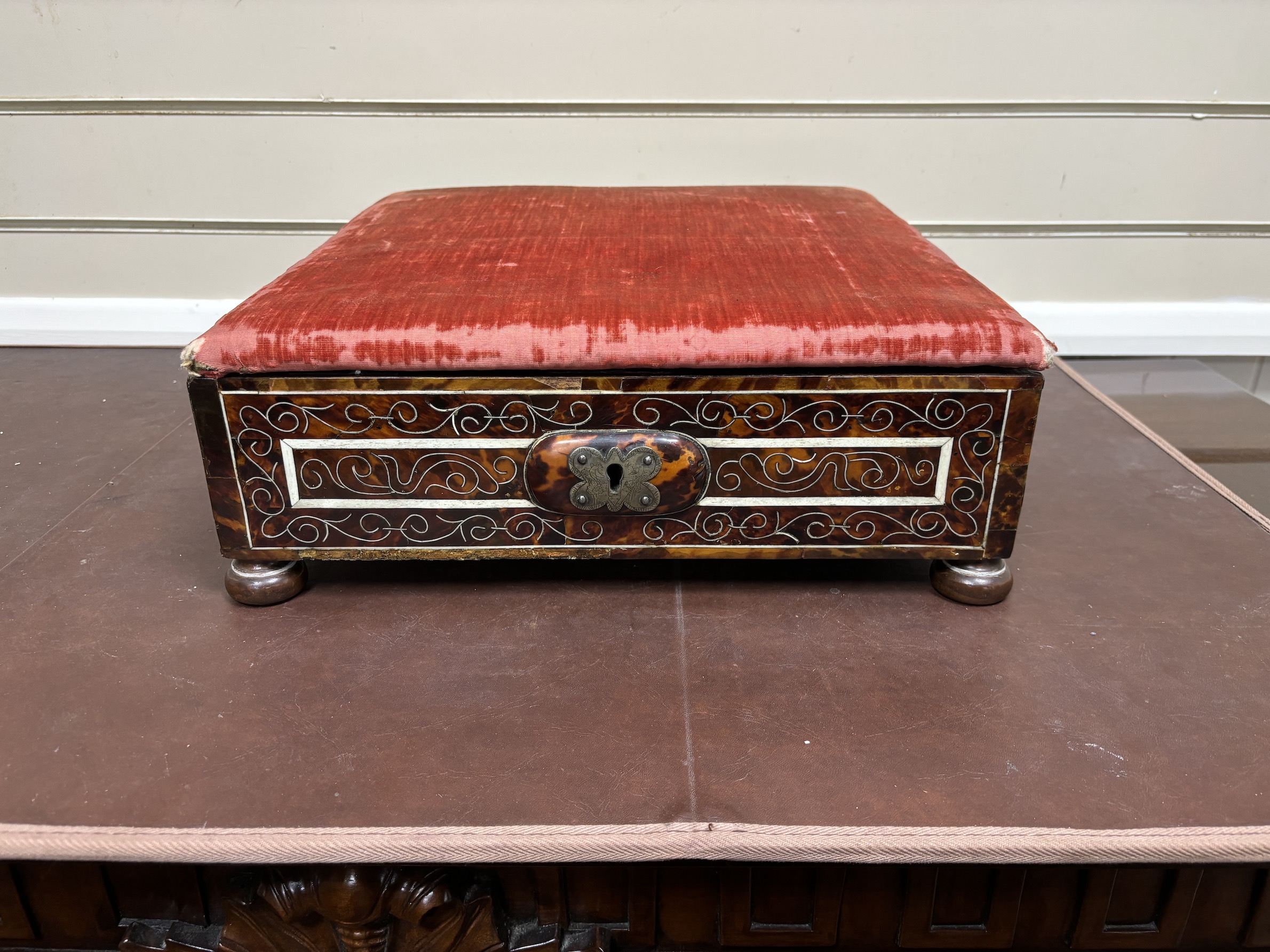 An 18th / early 19th century Portuguese tortoiseshell box with bone inlay and silk velvet lining with matching padded top, on bun feet, width 39cm, depth 38cm, height 16cm